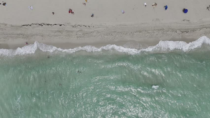 Aerial view of Miami Beach coastline with turquoise Atlantic water, sandy shore and urban waterfront, Florida USA. g.