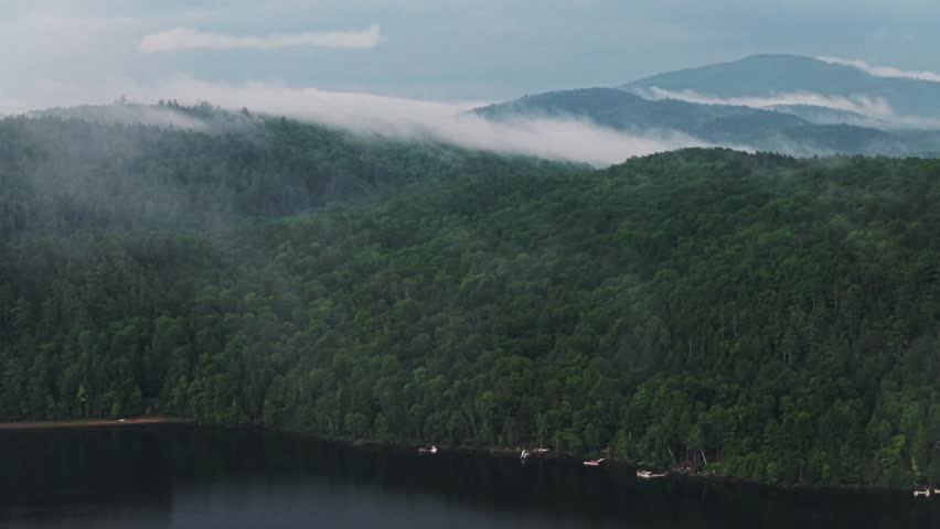 Lake Schroon rainy mist low clouds sunset aerial drone Steep Bay Town of Schroon Lake Up State New York Pharaoh Mtn Adirondack Mountains June July summer harbor view lake homes landscape circle left