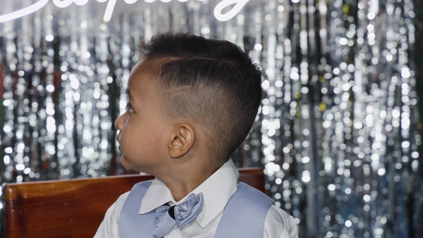 Smiling Young Boy in Formal Blue Suit dancing in flow During Birthday Celebration Portrait