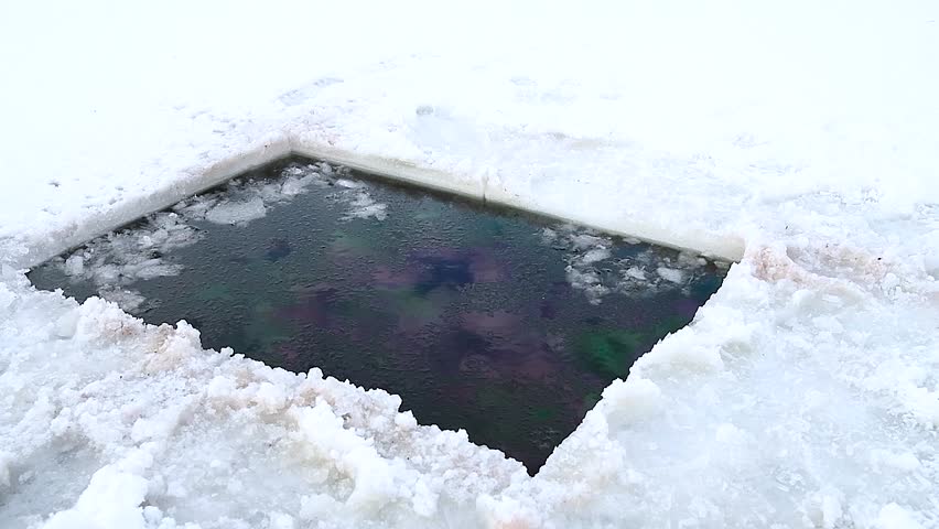 Hole in the ice carved out for swimming, hardening winter. Ice swimming place.