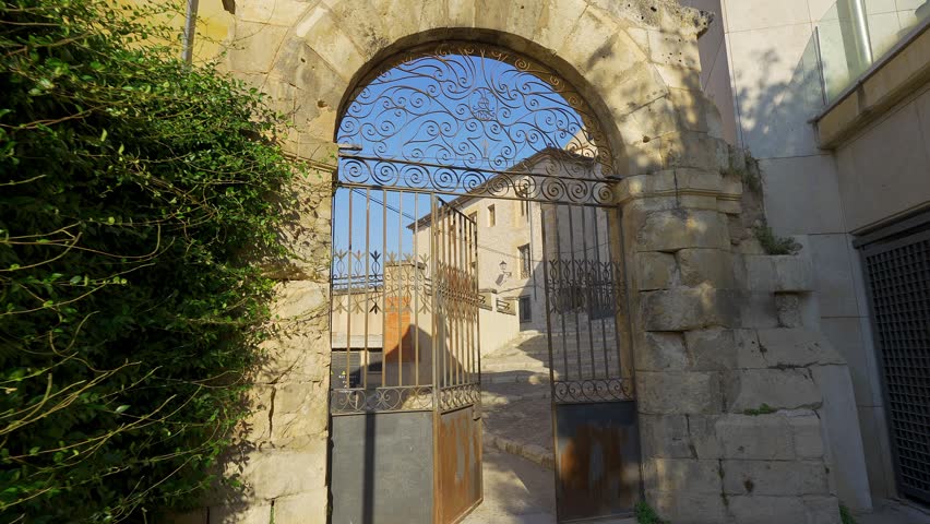 Arched passage opening to a green ravine in the historic San Andres neighborhood of Cuenca
