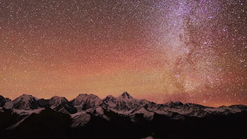 Time-lapse video showing the transition from star-filled night sky to golden sunrise over  Gongga Mountain, the highest peak in Sichuan. Countless stars fade away as dawn breaks, sunlight illuminates the snow-capped mountain ridge. Epic night-to-day natural landscape for travel documentaries and nature films.