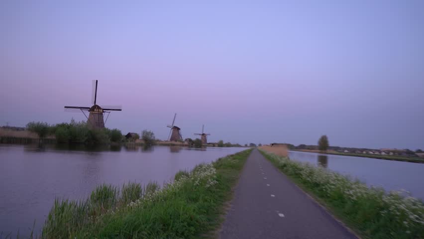 Two Geese Flying over Canal at Kinderdijk during Dusk

Two wild geese flying in formation over a calm water canal at dusk with a colorful sunset sky in Kinderdijk, Netherlands.