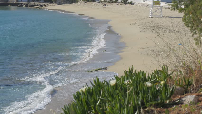 Sandy Coast With Calm Waves At Agios Stefanos Beach Near Mykonos Town, Greece. Wide Shot