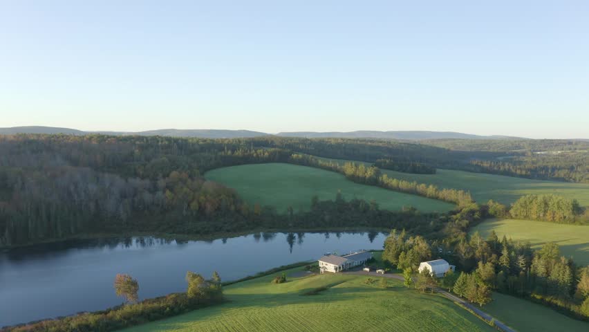Rural Farmhouse Beside a Peaceful Lake in the Canadian Countryside Aerial Drone View