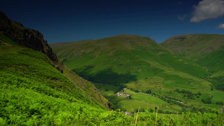 Lush green valley lit by sunlight