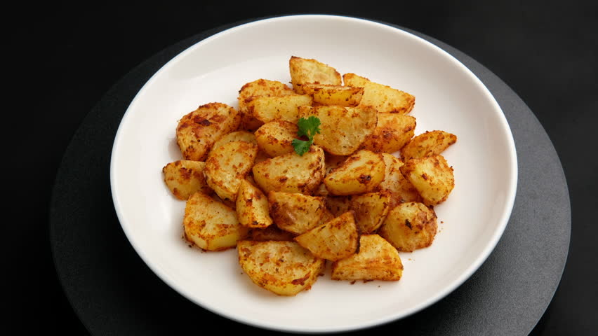 paprika flavor potato.Air fryer baked potatoes in white plate.Healthy cooking.