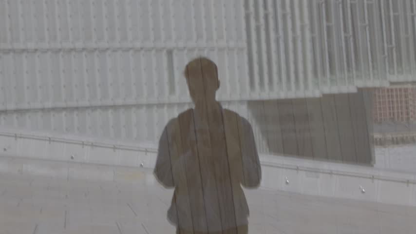 Shadow reflection of person with Oslo Opera House and Deichman library