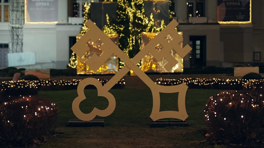 Historic Riga city keys glow before the National Opera amid magical festive lights.