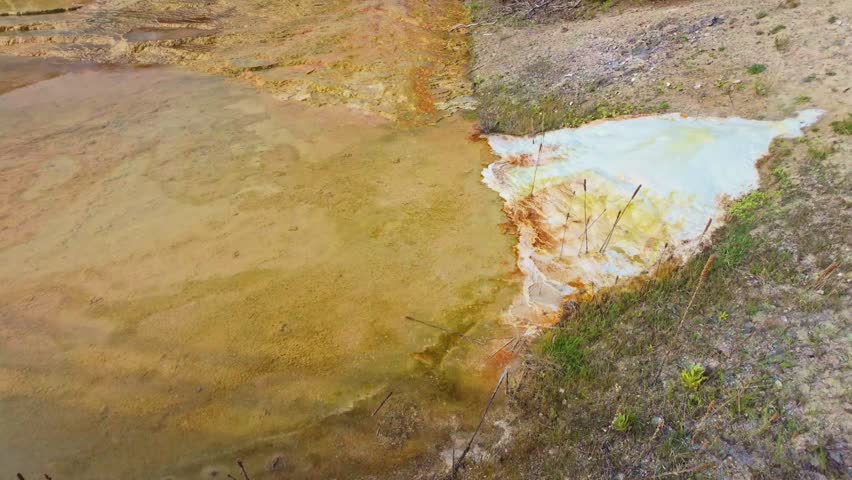 Steam rises above the colorful travertine terraces of Mammoth Hot Springs in Yellowstone National Park