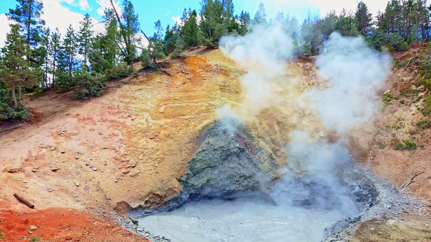 Steam rises above the bubbling Mud Volcano geothermal feature in Yellowstone National Park