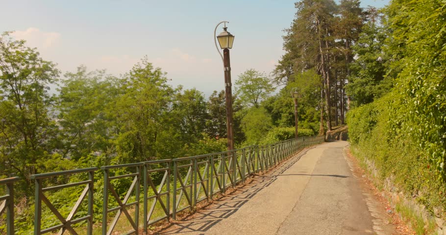 A Fenced Narrow Road Leads Toward Superga Hill Near Turin, Italy. Wide Shot