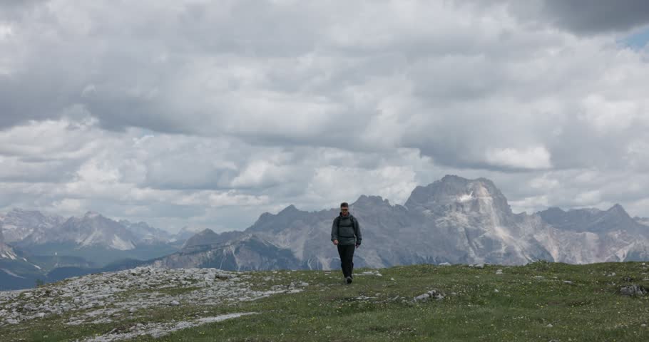 A male hiker walks through Cinque Torri in Cortina d