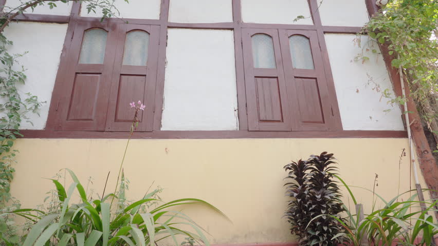 Closed windows of a traditional Assamese house