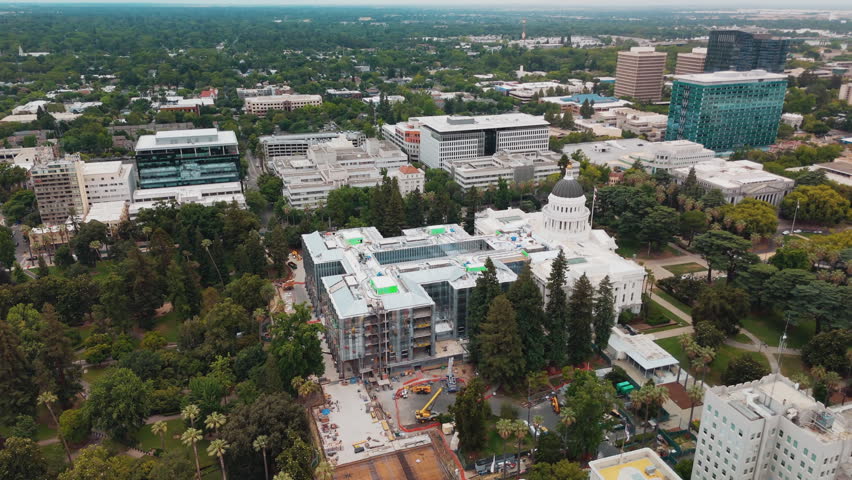 Construction progress at the California State Capitol Annex project in Sacramento, California, USA, showing the developing government building and active work site - drone shot