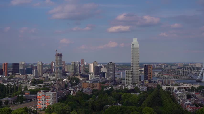 Rotterdam Skyline View with Zalmhaven Tower and Erasmus Bridge

Panoramica skyline view of Rotterdam cityscape featuring the tall Zalmhaven tower and Erasmus Bridge, observed from the Euromast observation tower in the Netherlands.