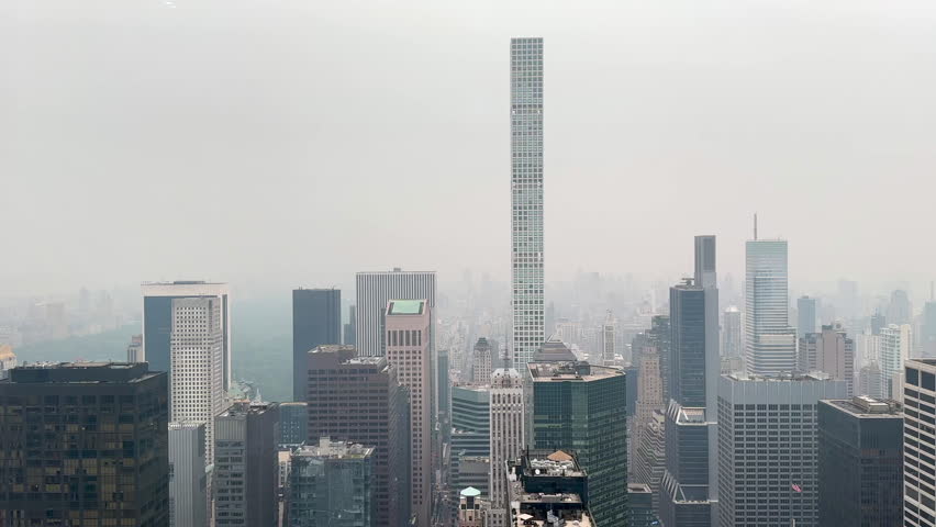 Daytime view overlooking Manhattan skyscrapers under an overcast sky as storm clouds gather above the city. Perfect for travel, business, architecture, and weather-related projects.