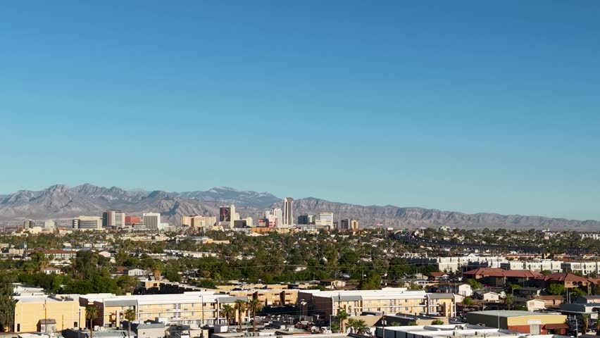 As the drone orbits the suburban neighborhood surrounding Las Vegas we see the skyline of Old Downtown Vegas. A slow pan across the sky reveals the growth of Sin City.