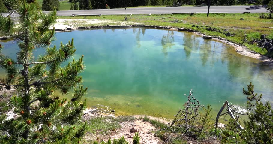 Green hot spring steaming at Yellowstone National Park, Wyoming
