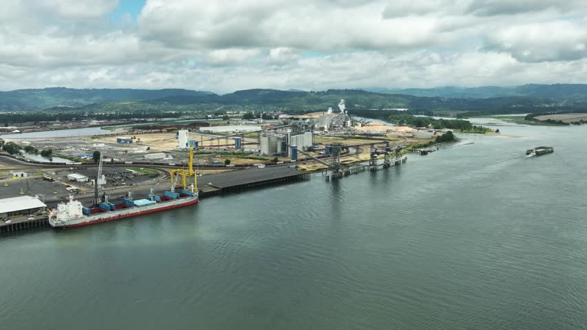 Large industrial facility by river with ship, Longview, Washington, USA.