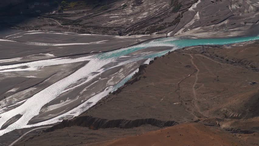 Confluence of the River Pin and River Spiti as seen from the top of the Dhankar Monastery in Spiti Valley, Himachal Pradesh, India. River flowing through a mountain valley. Dramatic nature background.