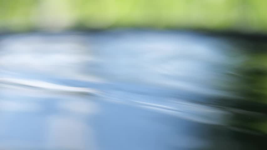 Water drops drip onto the water surface.