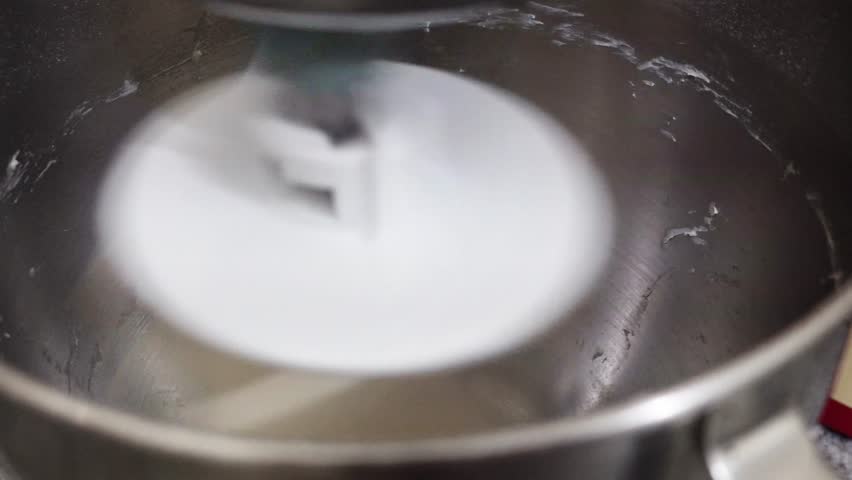 Close-up of bread dough being kneaded inside a homemade stand mixer, highlighting baking preparation and fresh bread making.