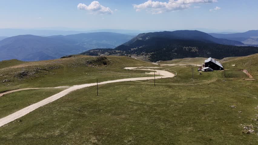Drone flyover above breathtaking mountain landscape with winding scenic trails