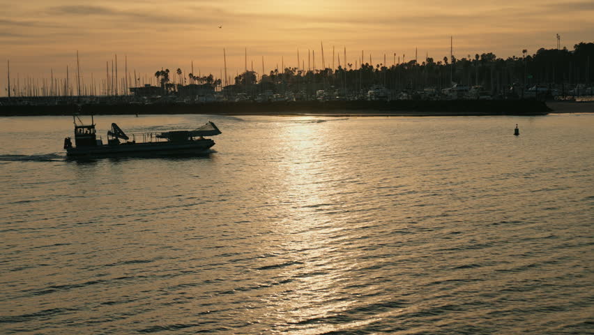 Fishing boat returning from the daily session with catch on board at sunset