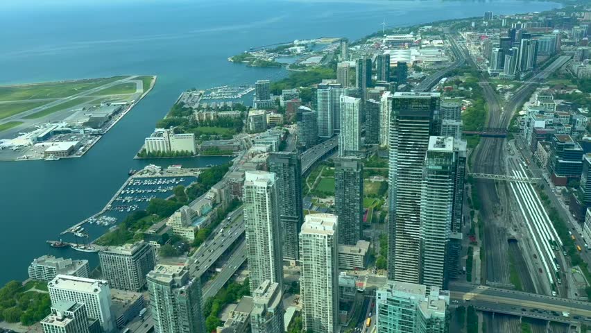 Beautiful view of the city of Toronto, Canada. Aerial perspective of a bustling urban cityscape featuring tall buildings, a waterfront area, and busy highways, showcasing the vibrant layout of the metropolitan region