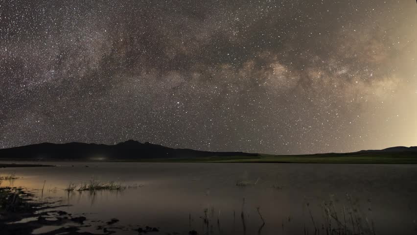 Beautiful night landscape , Milky Way  galaxy on the sky over the lake and mountains Space, night scene time lapse.
