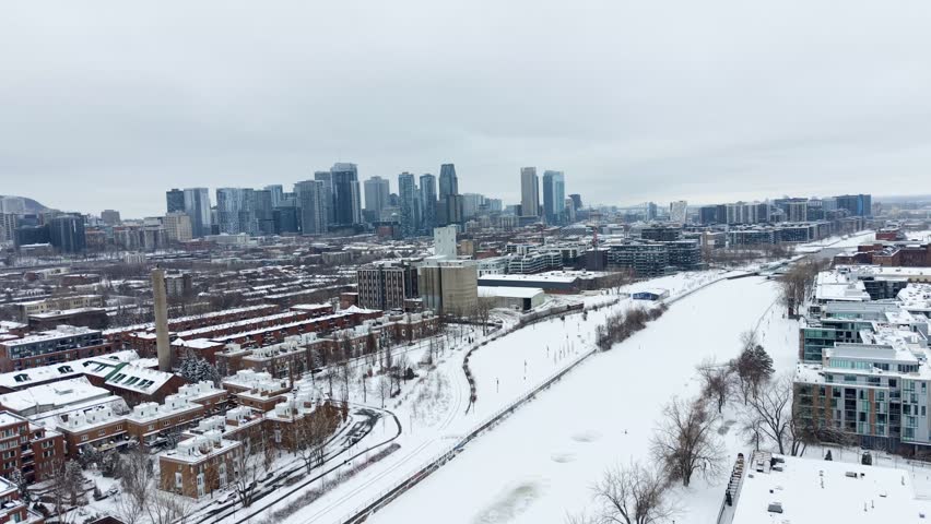 Winter aerial view of Griffintown and Lachine Canal with downtown Montreal skyline, Quebec, Canada. g.