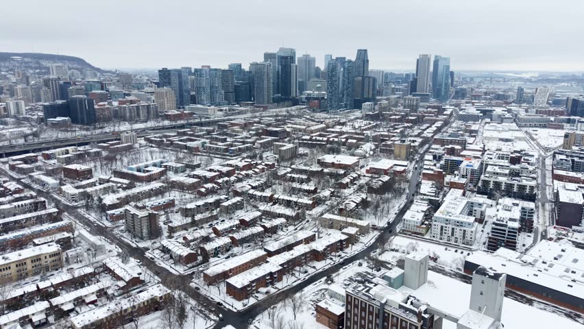 Winter aerial view of Griffintown and Lachine Canal with downtown Montreal skyline, Quebec, Canada. g.