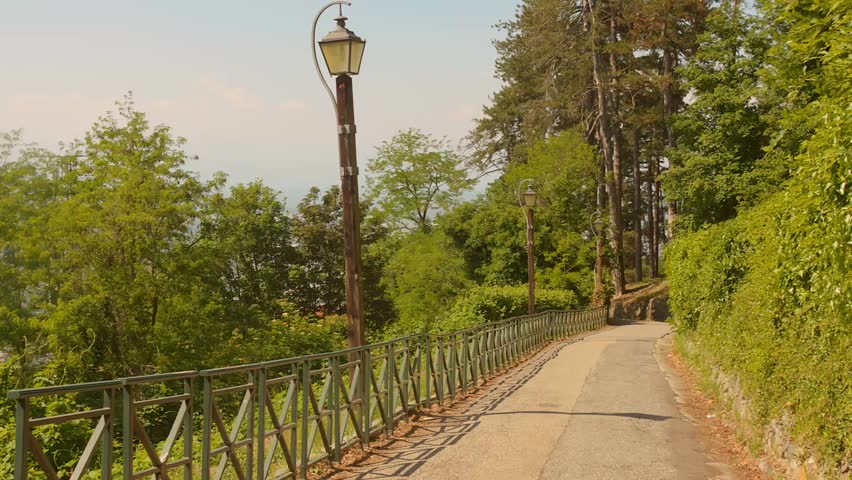 A Fenced Narrow Road Leads Toward Superga Hill Near Turin, Italy.