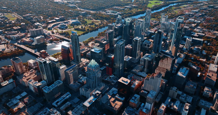 Austin, USA, 21 November 2025: Footage high above the modern Austin downtown, Texas, USA, the Colorado River and green waterfront across the river. Revealing view on the location for construction site in the city center.