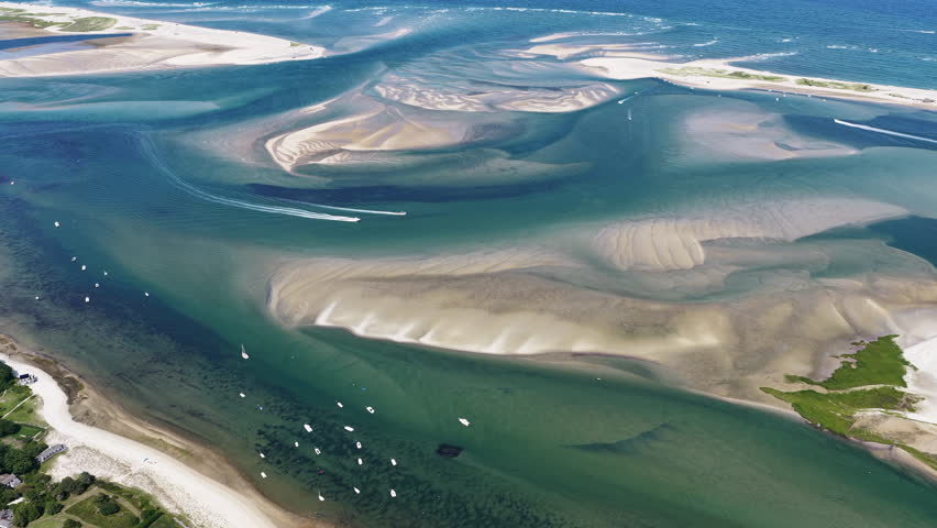 The Atlantic Ocean washes against the beautiful coast of Chatham on Cape Cod, Massachusetts. This outer Cape is a popular and scenic east coast vacation destination during summer months.