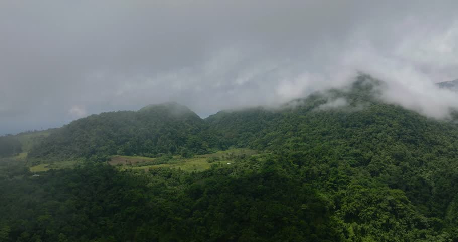 Fogs over the mountain slopes with rainforest in Camiguin Island. Philippines.