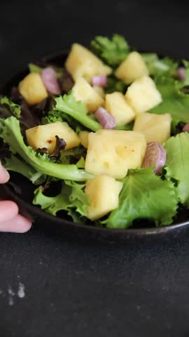 Pineapple Salad mixed green salad leaves and pineapple chunks food preparation tasty snack fresh gourmet food background on the table rustic food top view copy space keto and paleo diets vegetarian and vegan food