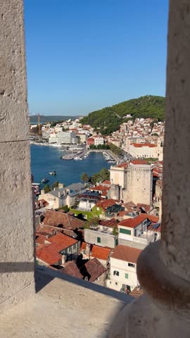 Split, Dalmatia, Croatia 4 September 2025; A view of Split’s old town reveals red-tiled rooftops, narrow stone streets, the Adriatic sea with boats at the dock and Marjan hill in the background. 
