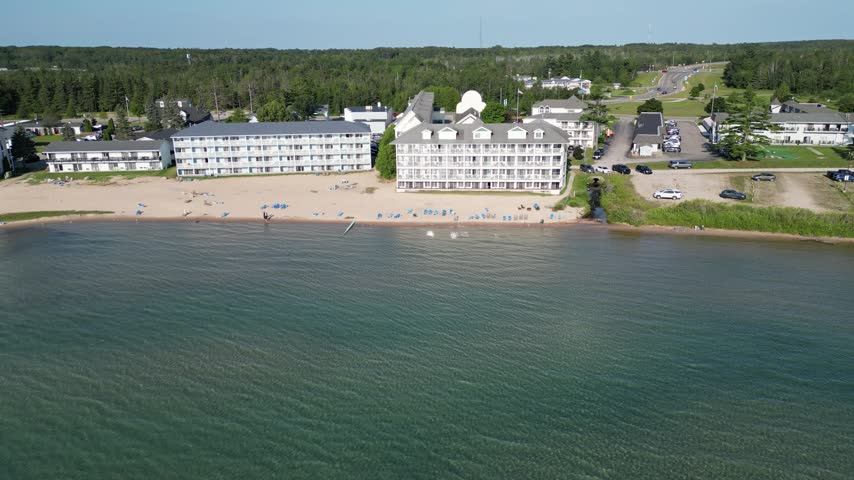 Aerial view of hotels and resorts lined up on the beaches of Lake Michigan. Far away vacation destination in the Great Lakes. Warm sands and cool green water.