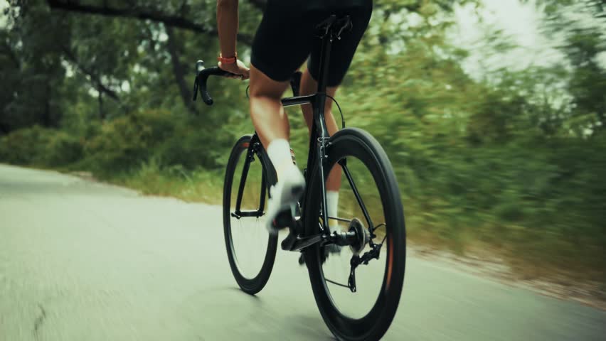 Triathlete Cyclist Training On Bicycle. Sport Cardio Workout. Fit Athlete Sport Workout Training Cycling Triathlon Competition. Sport Cyclist Fitness Cycling Road Bike Triathlon Race Recreation Sport