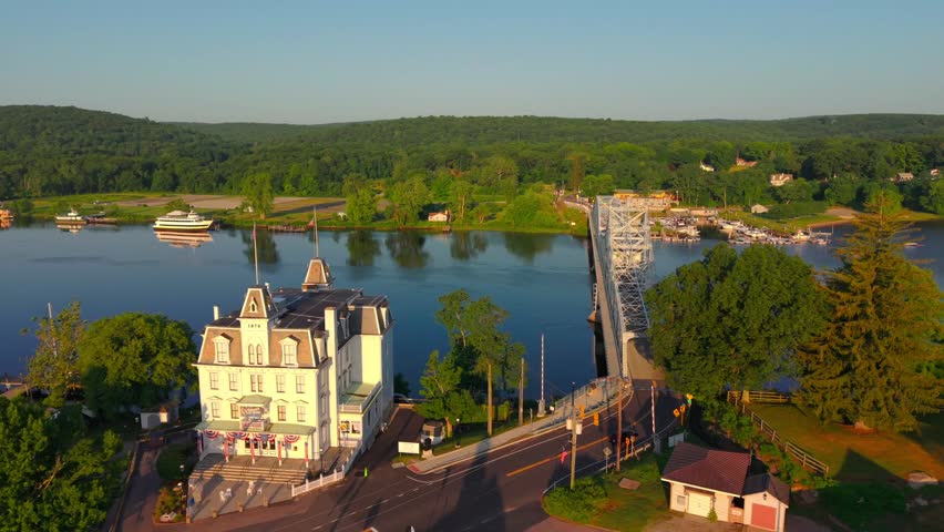 Summer aerial view featuring the East Haddam Swing Bridge and the Goodspeed Opera House in East Haddam, Connecticut just after sunrise