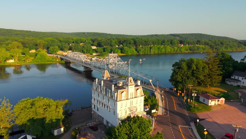 Summer aerial view featuring the East Haddam Swing Bridge and the Goodspeed Opera House in East Haddam, Connecticut just after sunrise