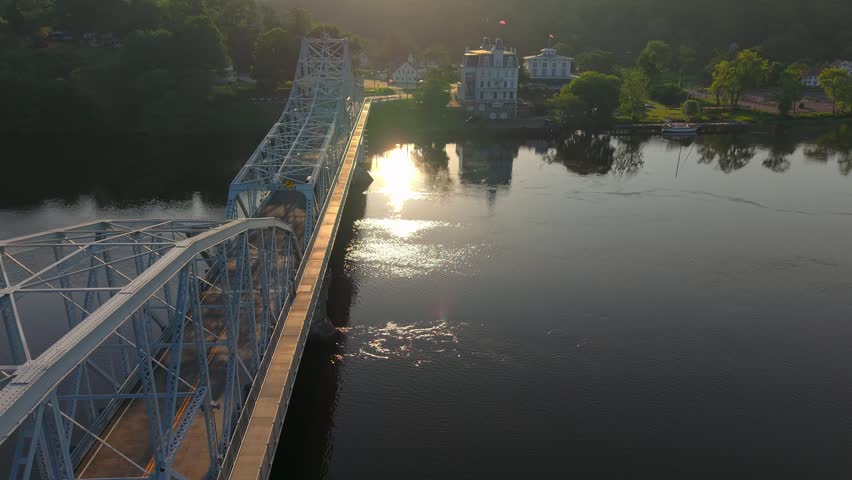 Summer aerial view featuring the East Haddam Swing Bridge and the Goodspeed Opera House in East Haddam, Connecticut just after sunrise