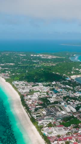 Tropical Island with white sand beach and ocean waves. Boracay, Philippines. Vertical view.