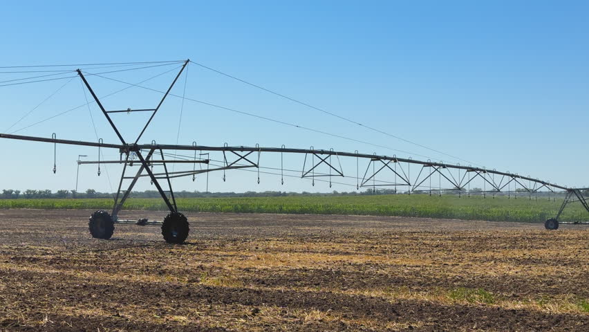 Center pivot irrigation system operating in a farm field