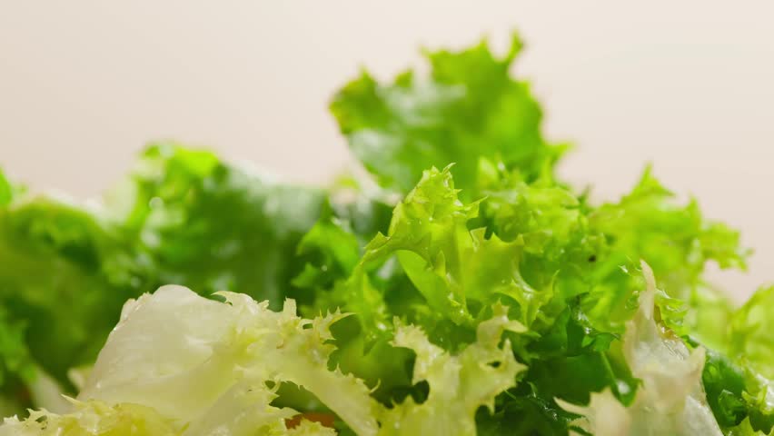Caesar Dressing or Creamy Sauce Pouring Over Fresh Green Caesar Salad Leaves in Bowl, Close Up of Healthy Food Preparation, Restaurant and Cafe Cooking Concept