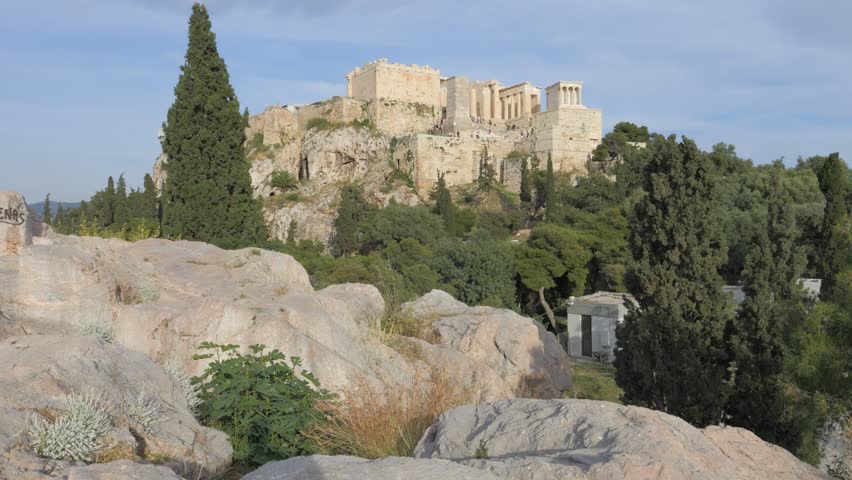 Ancient Acropolis hill with the Parthenon temple under a blue sky on a sunny day in Athens