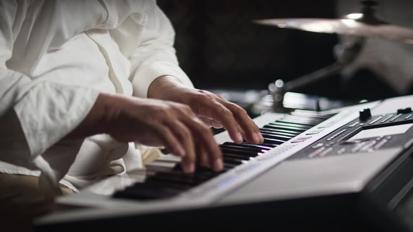 Close Up of Hands Playing Piano Keyboard	