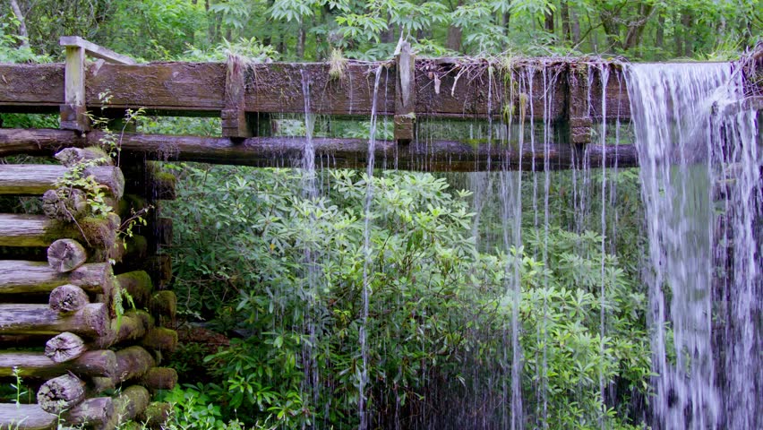 Water flowing at the Mingus Mill in the Great Smoky Mountains National Park in the summer with stable video.
